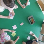 Czworo dzieci siedzi przy stoliku i tworzy kartki
