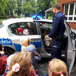 Dzieci oglądają radiowóz. 