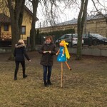 kobieta obok kukły Marzanny na placu przedszkolnym.